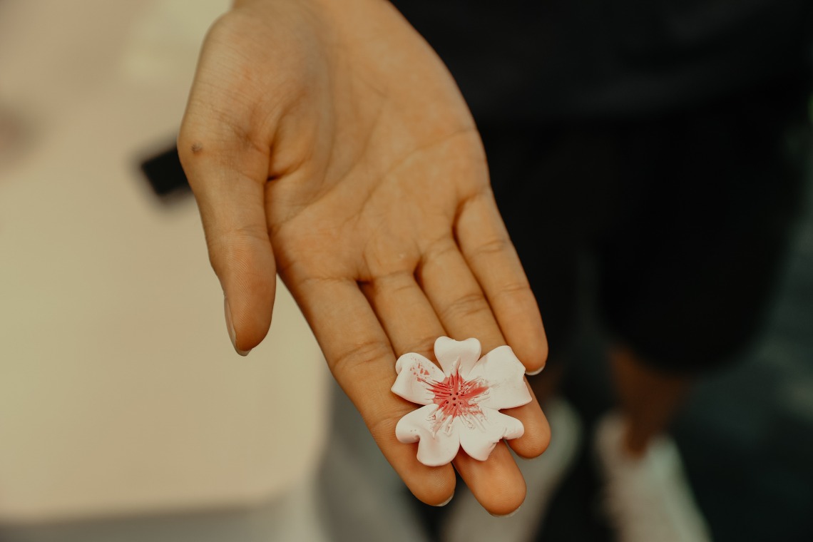 clay flower on hand